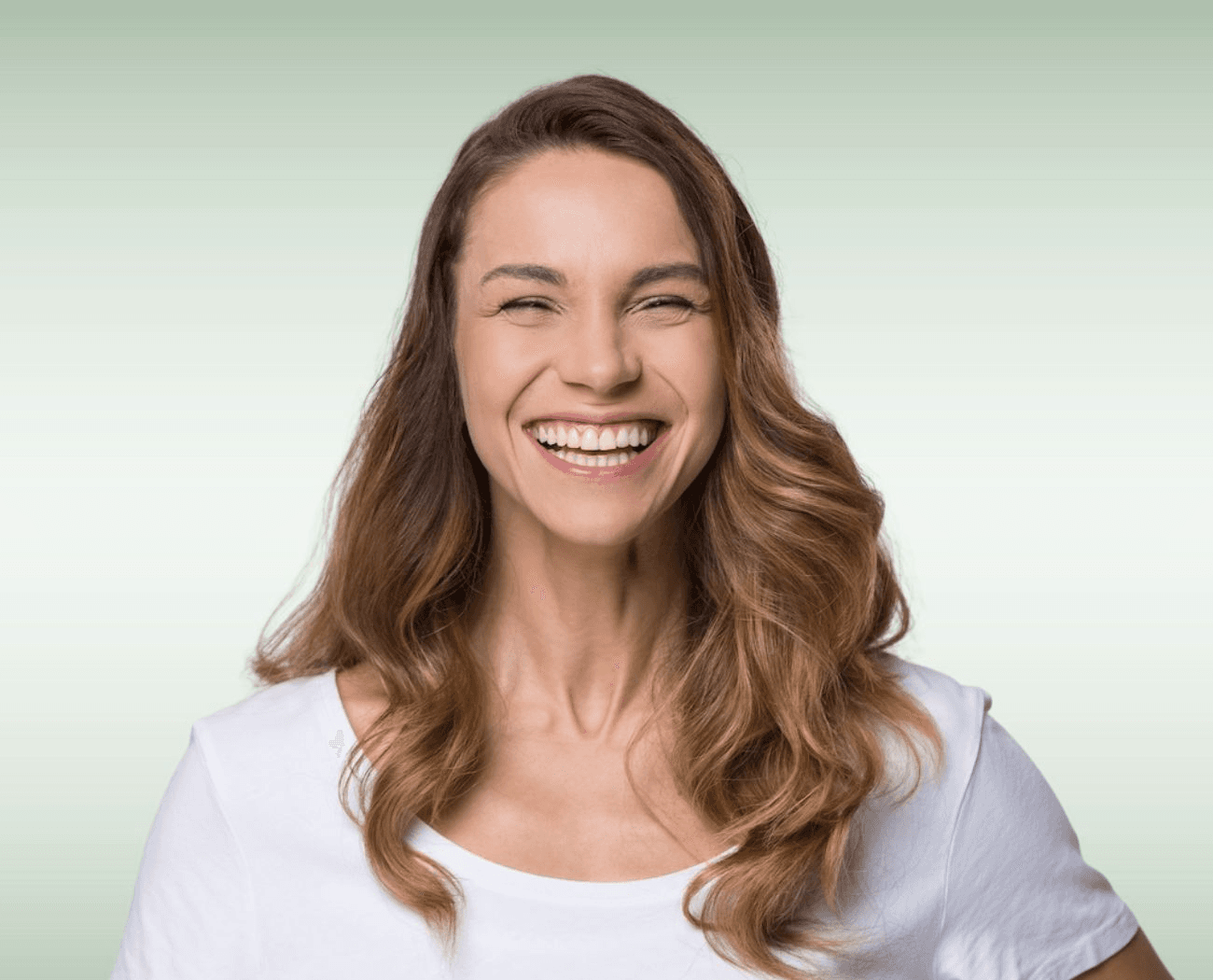 Woman laughing with a confident smile after dental crown restoration at Esthetique Dentistry Ashburn VA