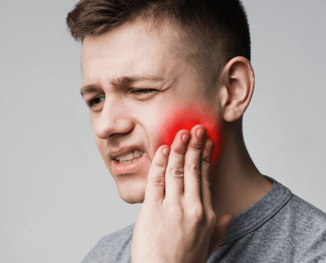 Young man experiencing severe tooth pain, Esthetique Dentistry Ashburn provides same-day emergency dental care