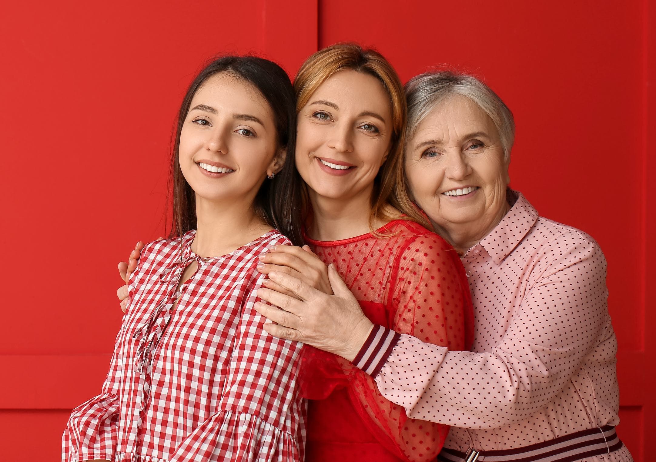 Three generations of family smiling at Esthetique Dentistry Ashburn