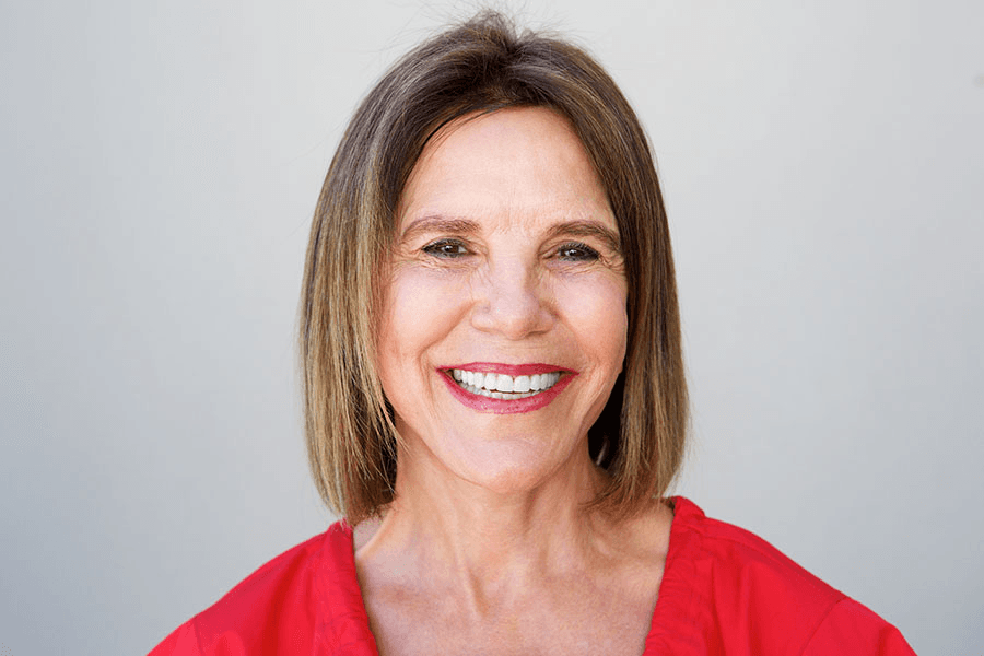 Woman with brunette bob smiling confidently after smile makeover at Esthetique Dentistry Ashburn